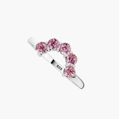 Silver ring with pink gemstones on a white background