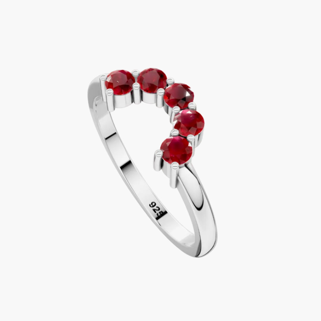 Silver ring with red gemstones on a white background