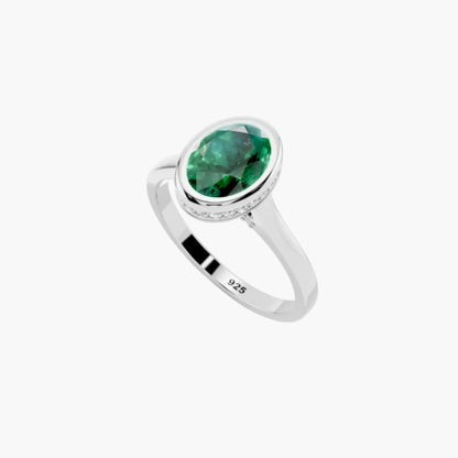 Silver ring with a green gemstone on a white background