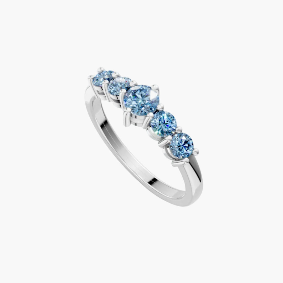 Silver ring with blue gemstones on a white background